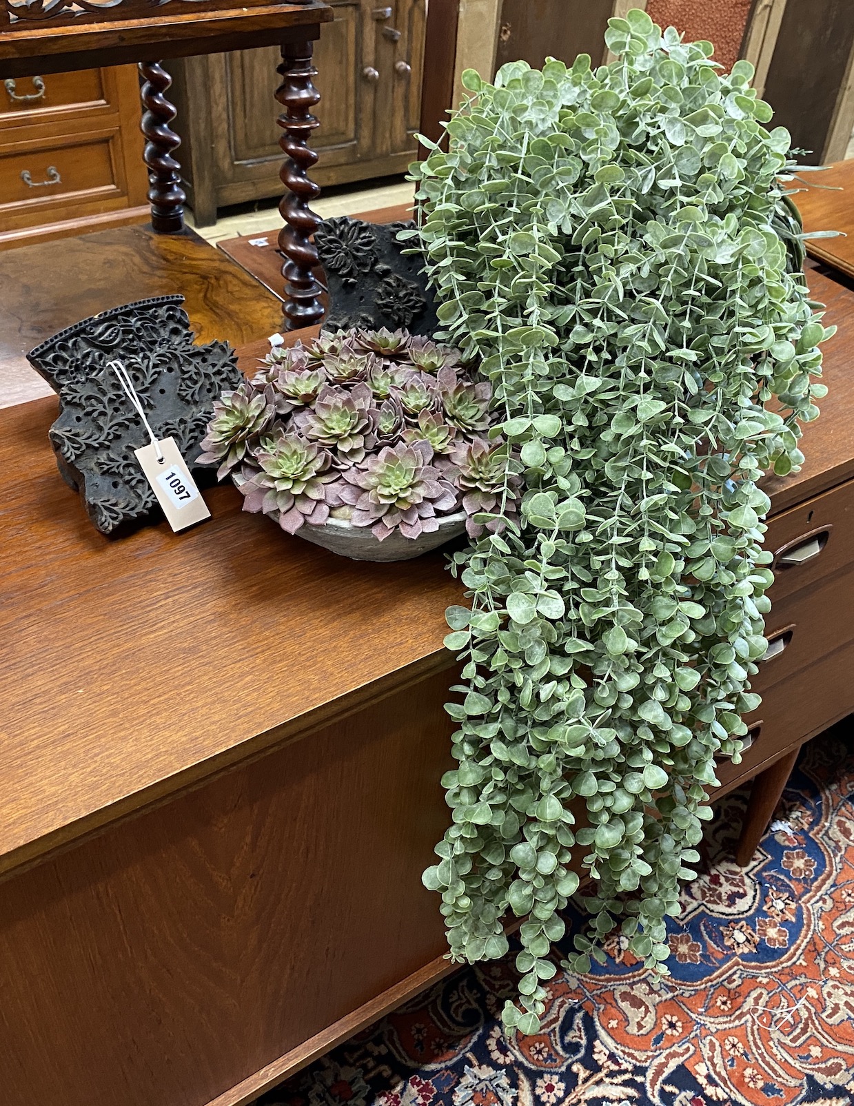 Two artificial plants together with three Indian wood blocks